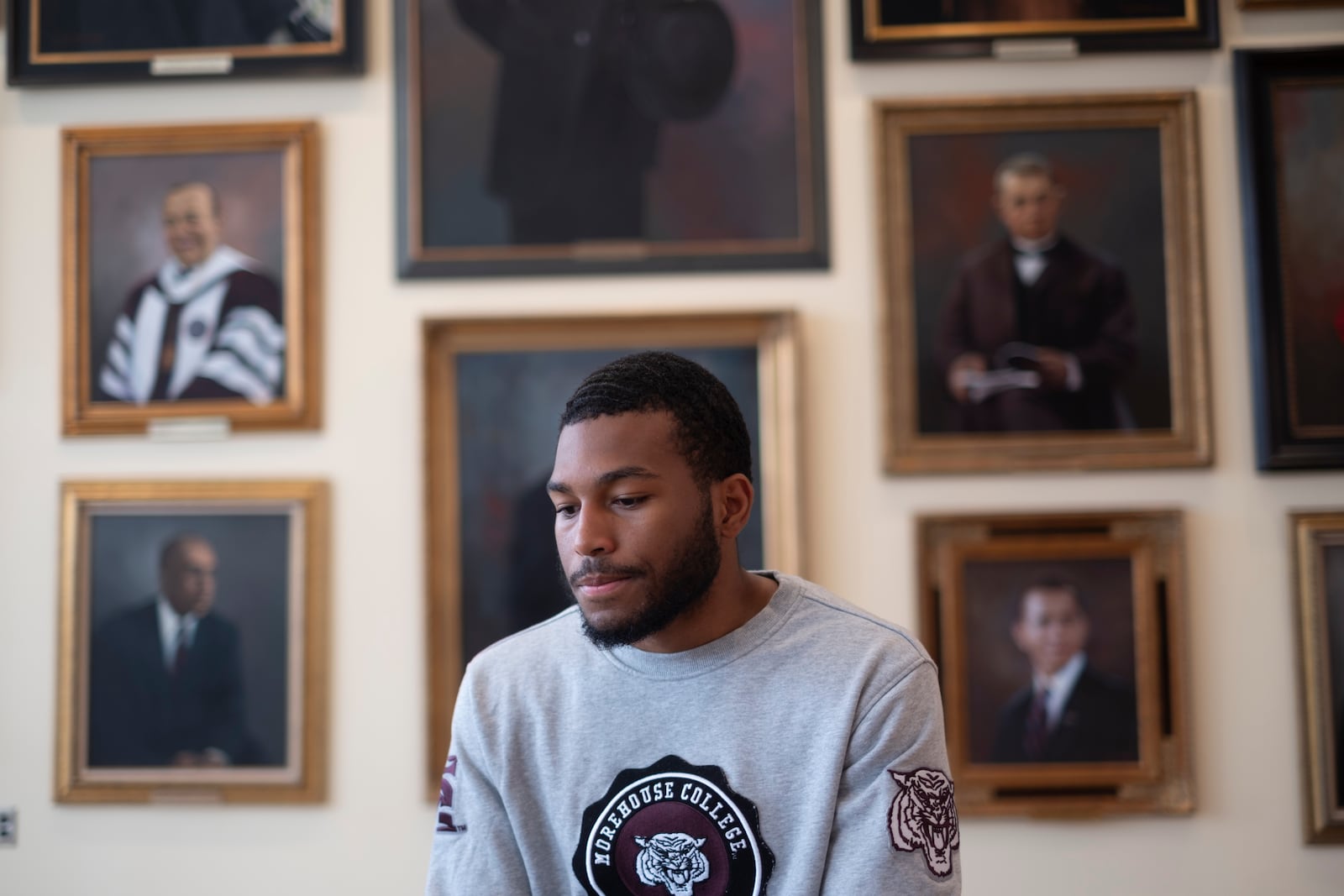 Jordan Phillips, a senior at Morehouse College, sits in the African American Hall of Fame during an interview about his feelings the morning after Vice President Kamala Harris didn’t win the presidential election. (Ben Gray for the AJC)