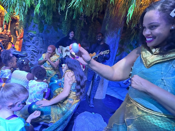 "The Little Mermaid" experience at the CAMP store features songs from the movie sung by actors like Brittani Minnieweather (right). RODNEY HO/rho@ajc.com