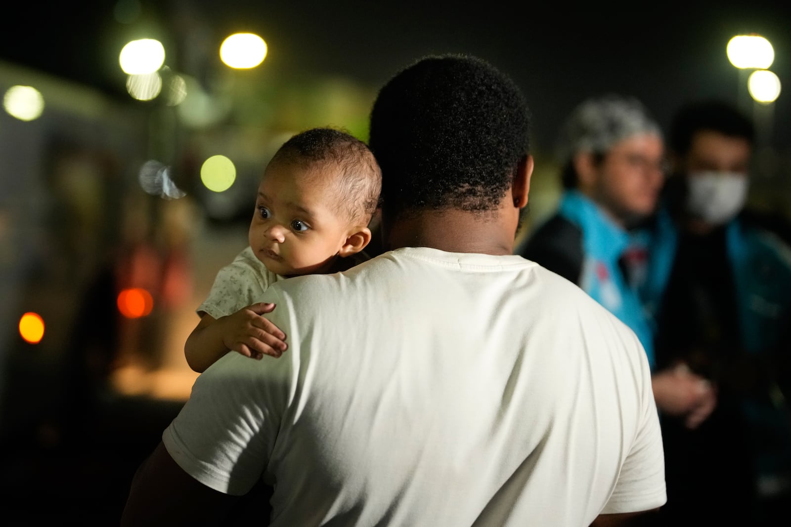 People mostly Turkish nationals disembark from Turkish TCG Sancaktar military ship after being evacuated from Lebanon's capital Beirut to Turkey, in Mersin port, southern Turkey, early Friday, Oct. 11, 2024. (AP Photo/Emrah Gurel)