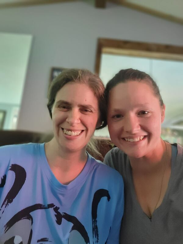 Renee Price (left) is recuperating with her sister, Rosie Robinson, at Robinson's metro Atlanta home after helping to rescue their siblings from a devastating fire. Price suffered burns on her back.