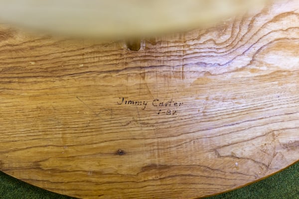 A children’s table made and signed by Jimmy Carter sits in Maranatha Baptist Church in Plains on Sunday, Feb. 26, 2023. (Arvin Temkar/AJC)