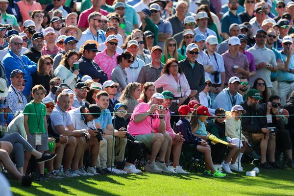 Patrons watch Tiger Woods practice on the 16th green during the practice round of the 2024 Masters Tournament at Augusta National Golf Club, Monday, April 8, 2024, in Augusta, Ga. (Jason Getz / jason.getz@ajc.com)