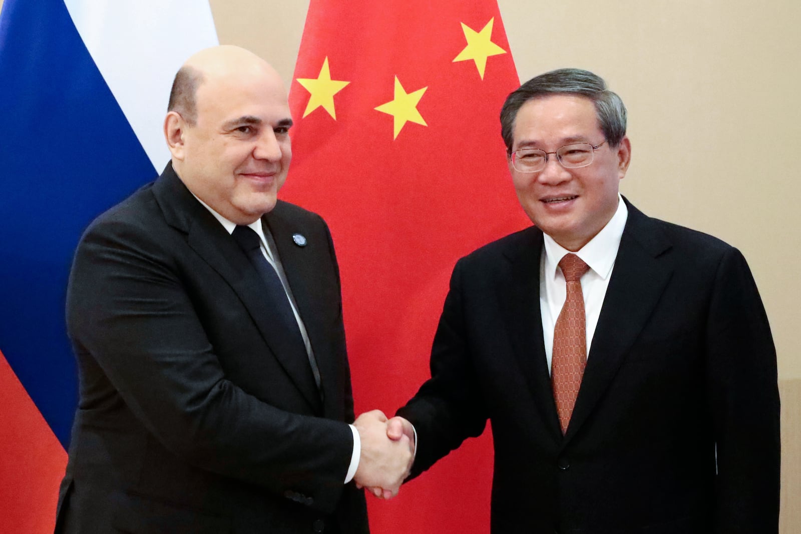 Chinese Premier Li Qiang, right, and Russian Prime Minister Mikhail Mishustin pose for a photo on the sidelines of the Shanghai Cooperation Organization (SCO) Council of Heads of Governments Summit in Islamabad, Pakistan, Wednesday, Oct. 16, 2024. (Roman Naumov, Sputnik, Government Pool Photo via AP)