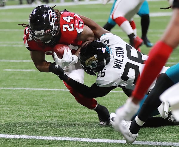 Atlanta Falcons running back Devonta Freeman catches a touchdown pass past Jacksonville Jaguars safety Jarrod Wilson in the first quarter and Sunday, Dec. 22, 2019, at Mercedes-Benz Stadium in Atlanta.