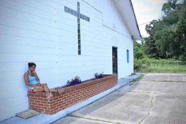 A woman experiencing homelessness sits outside of a homeless encampment at 1803 G Street. She is one of about 20 people who stay here since The Well temporarily closed. (Photo Courtesy of Kailey Cota)