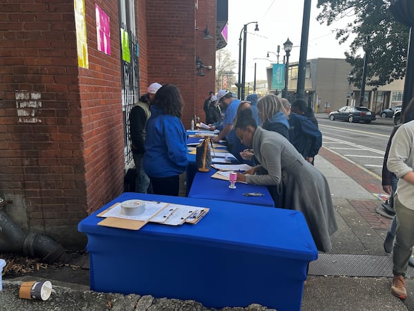 Volunteers gather signatures from those who attended Robert F. Kennedy Jr.’s rally in Atlanta on Jan. 14, 2024. (Greg Bluestein/greg.bluestein@ajc.com)