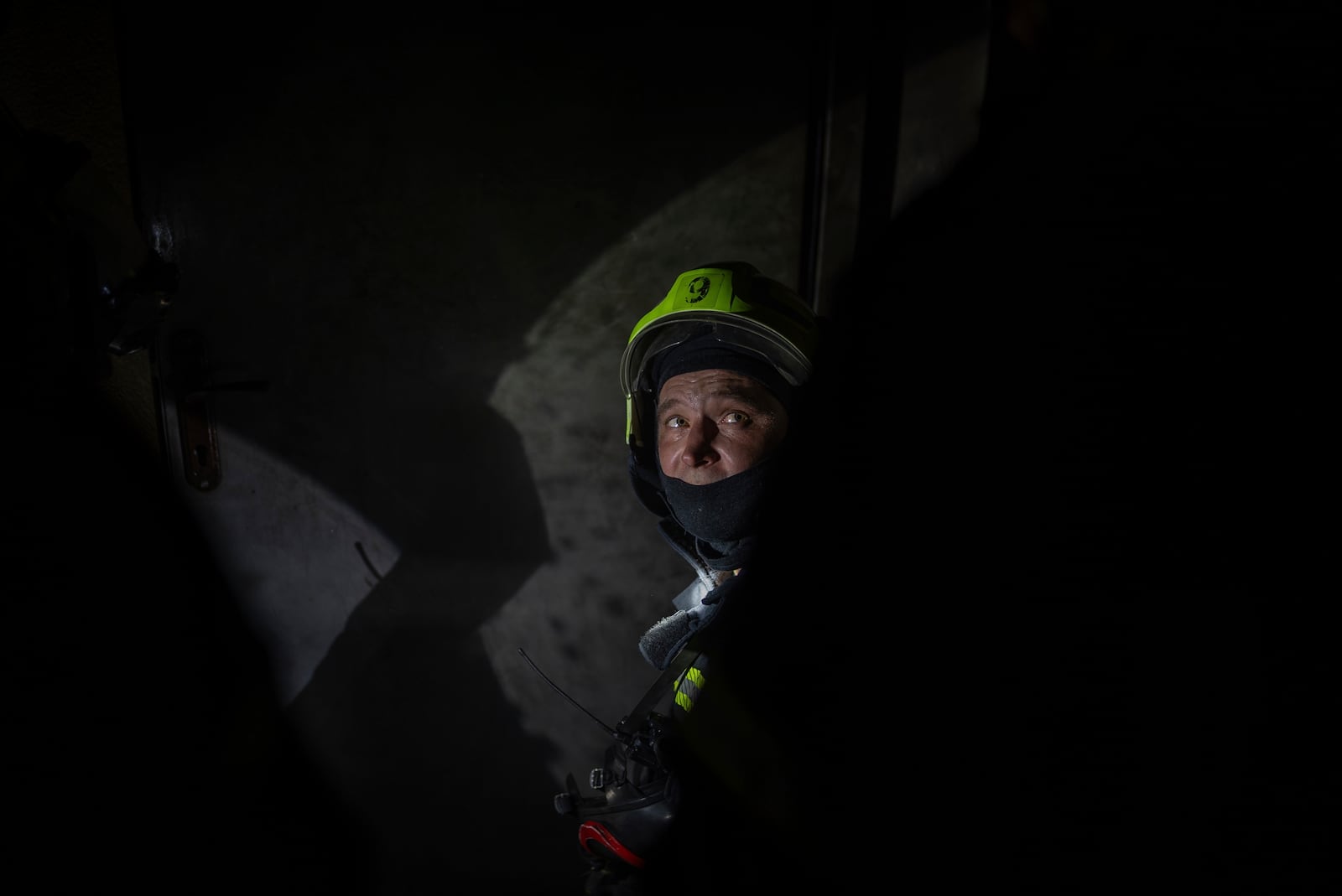 A firefighter looks on from a floor that burned down after a Russian attack killed a teenager in Kyiv, Ukraine, Friday, Oct. 25, 2024. (AP Photo/Alex Babenko)