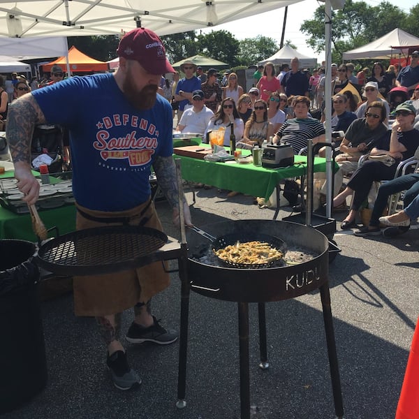 Chef demos are a popular feature of many farmers markets. Chef Kevin Gillespie demonstrates a grilled seasonal dish at the Peachtree Road Farmers Market. CONTRIBUTED BY CARLA GRADY