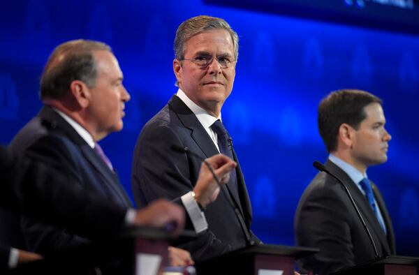 Mike Huckabee, left, speaks as Jeb Bush, center and Marco Rubio look on during the CNBC Republican presidential debate at the University of Colorado, Oct. 28, 2015, in Boulder, Colo. (AP Photo/Mark J. Terrill)