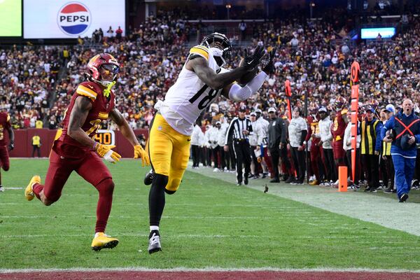 Pittsburgh Steelers wide receiver Mike Williams (18), defended by Washington Commanders cornerback Benjamin St-Juste (25), pulls in a 32-yard reception for a touchdown 'during the second half of an NFL football game, Sunday, Nov. 10, 2024, in Landover, Md. (AP Photo/Nick Wass)