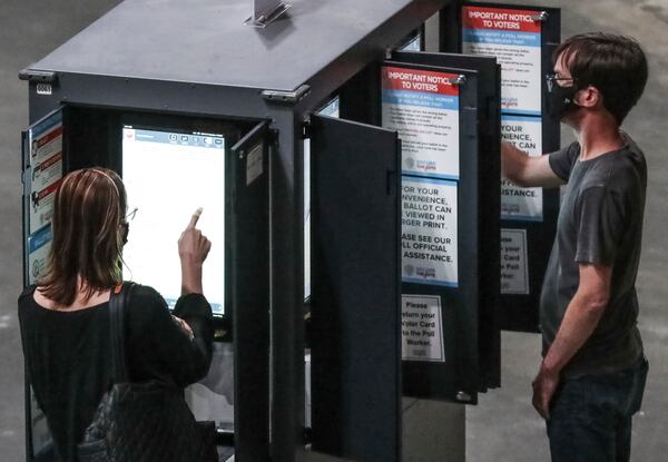 Voters cast their ballots on Monday, Oct. 12, 2020 at State Farm Arena in downtown Atlanta. (John Spink / John.Spink@ajc.com)