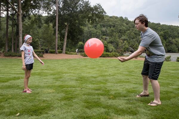 08/07/2018 -- Atlanta, Georgia -- Logan Delaney [cq] (right) plays with his little sister Lexie Delaney[cq] in their apartment complex in Atlanta, Tuesday, August 7, 2018.  (ALYSSA POINTER/ALYSSA.POINTER@AJC.COM)