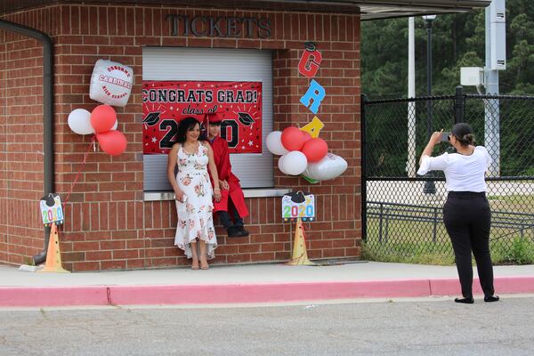 An Osborne High School graduate who received his cap and gown poses for a photo.