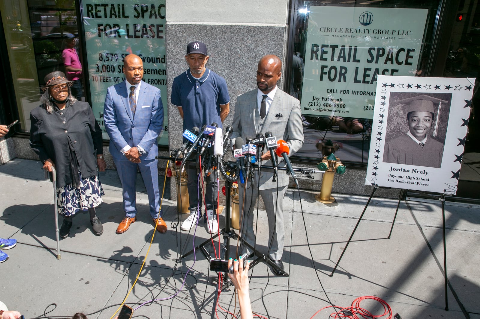 FILE - From right, attorney Donte Mills; Jordan Neely's father, Andre Zachery; attorney Lennon Edwards; and Neely's aunt Mildred Mahazu appear at a news conference in New York City, May 12, 2023. (AP Photo/Ted Shaffrey, File)