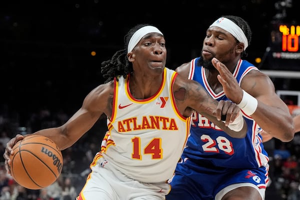 Atlanta Hawks guard Terance Mann (14) drives against Philadelphia 76ers forward Guerschon Yabusele (28) during the first half of an NBA basketball game, Monday, March 10, 2025, in Atlanta. (AP Photo/Mike Stewart)