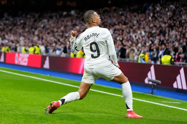 Real Madrid's Kylian Mbappe celebrates after scoring his side's opening goal during the Spanish La Liga soccer match between Real Madrid and Rayo Vallecano at the Santiago Bernabeu stadium in Madrid, Spain, Sunday, March 9, 2025. (AP Photo/Manu Fernandez)