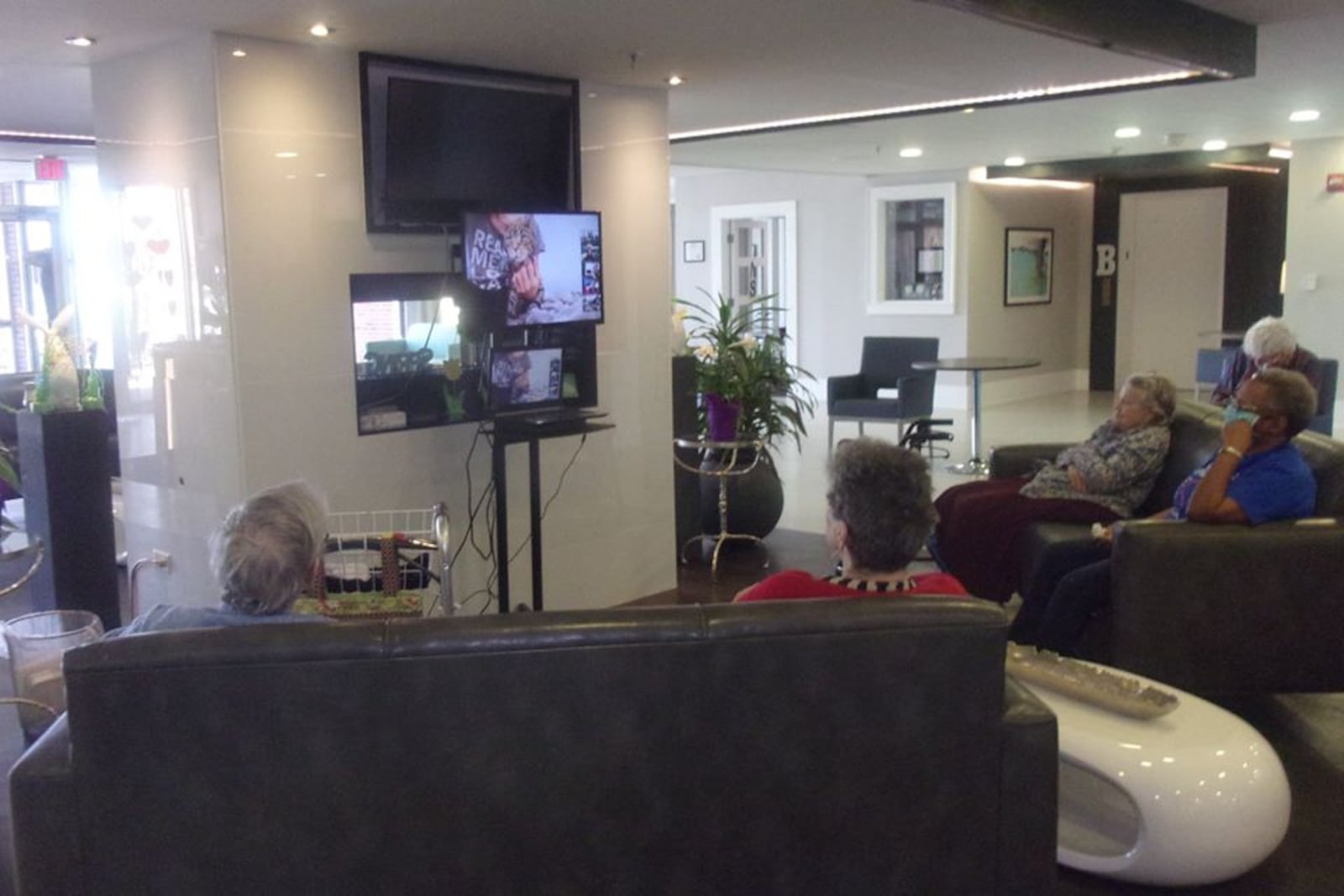 These seniors are interacting with volunteers and their pets during a Pets Together chat call. Pets Together is a free virtual pet visit being offered across the country to those living in group settings, such as nursing homes and senior living communities. Courtesy of Pets Together