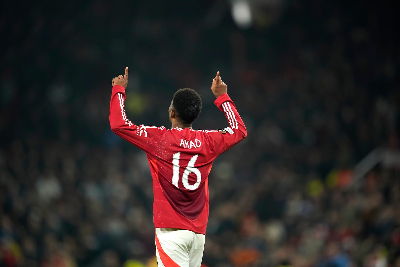 Manchester United's Amad Diallo celebrates after scoring his side's second goal during the Europa League opening phase soccer match between Manchester United and PAOK at the Old Trafford stadium in Manchester, England, Thursday, Nov. 7, 2024. (AP Photo/Dave Thompson)