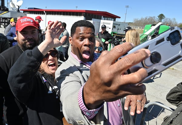 Former football star Herschel Walker, center, was a household name in Georgia long before he began his campaign in the 2022 midterm against Democratic U.S. Sen. Raphael Warnock. (Hyosub Shin / Hyosub.Shin@ajc.com)