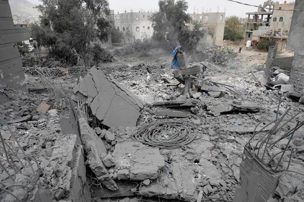 A Yemeni walks over the debris of a destroyed building after it was struck by U.S. airstrikes in Sanaa, Yemen, Monday, March 24, 2025. (AP Photo)