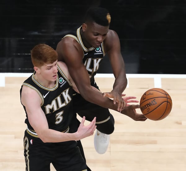 Atlanta Hawks Kevin Huerter and Clint Capela (right) look to collect the offensive rebound against the Minnesota Timberwolves Monday, Jan. 18, 2021, at State Farm Arena in Atlanta. (Curtis Compton / Curtis.Compton@ajc.com)