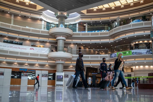 11/23/2020 �  Atlanta, Georgia �People walk through the atrium in the Domestic Terminal at Hartsfield-Jackson Atlanta International Airport in Atlanta , Monday, November 23, 2020.  (Alyssa Pointer / Alyssa.Pointer@ajc.com)