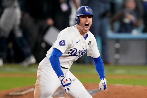 Los Angeles Dodgers' Freddie Freeman celebrates after hitting a walk-off grand slam home run during the 10th inning in Game 1 of the baseball World Series against the New York Yankees, Friday, Oct. 25, 2024, in Los Angeles. (AP Photo/Mark J. Terrill)