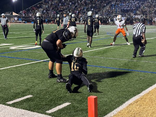 Guard Ryan Walker (L) consoles Timothy Clark in the end zone after the go-ahead touchdown pass was knocked away on fourth-down by a Stockbridge player. Stockbridge won the game 14-10 on Oct. 4, 2024.