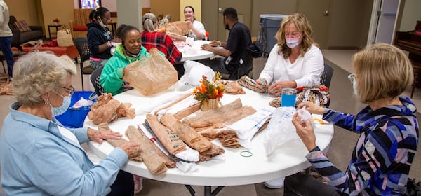 Bags2Blankets volunteers Barbara Conrad (from left), Erika Gill, Janis Sims and Kristy Ross help prepare plastic bags to be weaved into blankets at Tucker United Methodist Church. PHIL SKINNER FOR THE ATLANTA JOURNAL-CONSTITUTION.