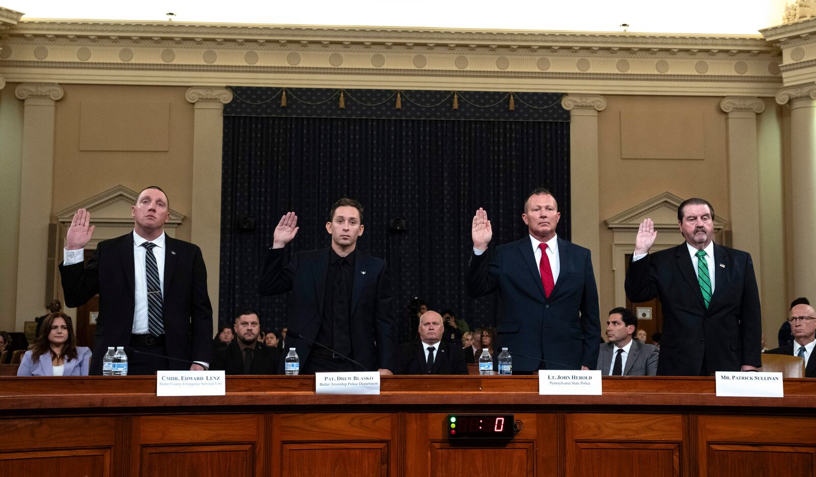 From left, Sgt. Edward Lenz, Commander of Butler County Emergency Services Unit, Patrolman Drew Blasko of Butler Township Police Dept., Lt. John Herold of Pennsylvania State Police, and former U.S. Secret Service agent Patrick Sullivan, swear in at the first public hearing of a bipartisan congressional task force investigating the assassination attempts against Republican presidential nominee former President Donald Trump, at Capitol Hill in Washington, Thursday, Sept. 26, 2024. (AP Photo/Ben Curtis)