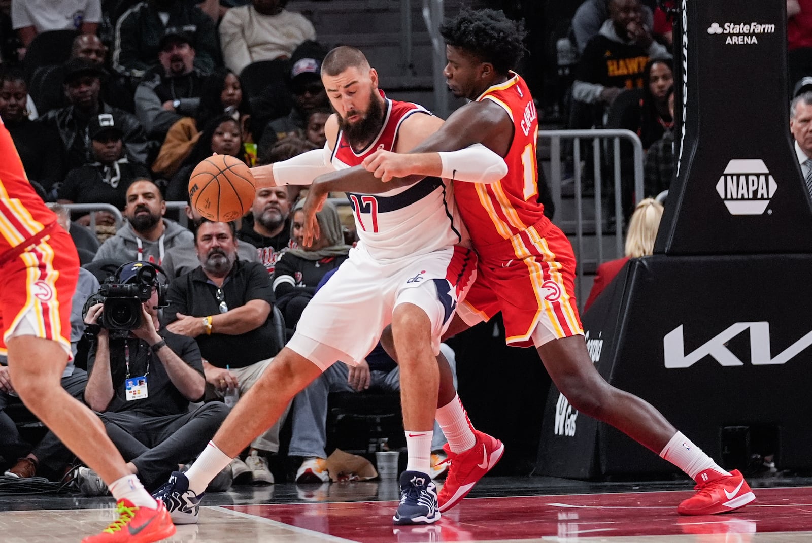 Washington Wizards center Jonas Valanciunas (17) works against Atlanta Hawks center Clint Capela (15) during the first half of an NBA basketball game Monday, Oct. 28, 2024, in Atlanta. (AP Photo/ John Bazemore)