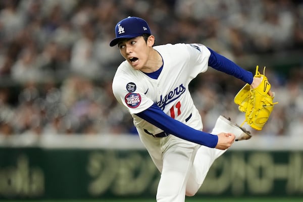 Los Angeles Dodgers starting pitcher Roki Sasaki throws to the Chicago Cubs during his Major League debut in the first inning of an MLB Tokyo Series baseball game in Tokyo, Japan, Wednesday, March 19, 2025. (AP Photo/Hiro Komae)