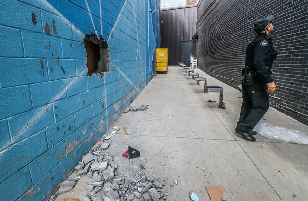 A hole could be seen in a cinderblock wall behind A Ma Maniére, where a burglary was reported shortly before 6 a.m. Thursday.