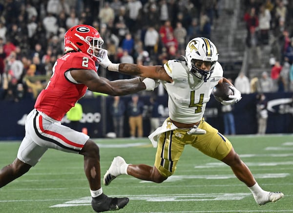 Georgia Tech running back Dontae Smith (4) runs against Georgia linebacker Smael Mondon Jr. (2) during the first half of an NCAA college football game at Georgia Tech's Bobby Dodd Stadium, Saturday, November 25, 2023, in Atlanta. Georgia won 31-23 over Georgia Tech. (Hyosub Shin / Hyosub.Shin@ajc.com)