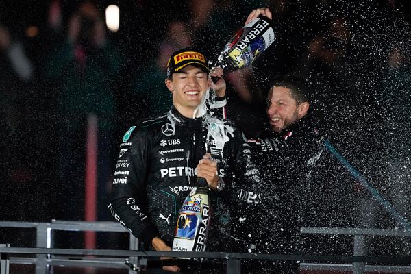 Mercedes driver George Russell, of Britain, celebrates on the podium after winning the F1 Las Vegas Grand Prix auto race, Sunday, Nov. 24, 2024, in Las Vegas. (AP Photo/Matt York)