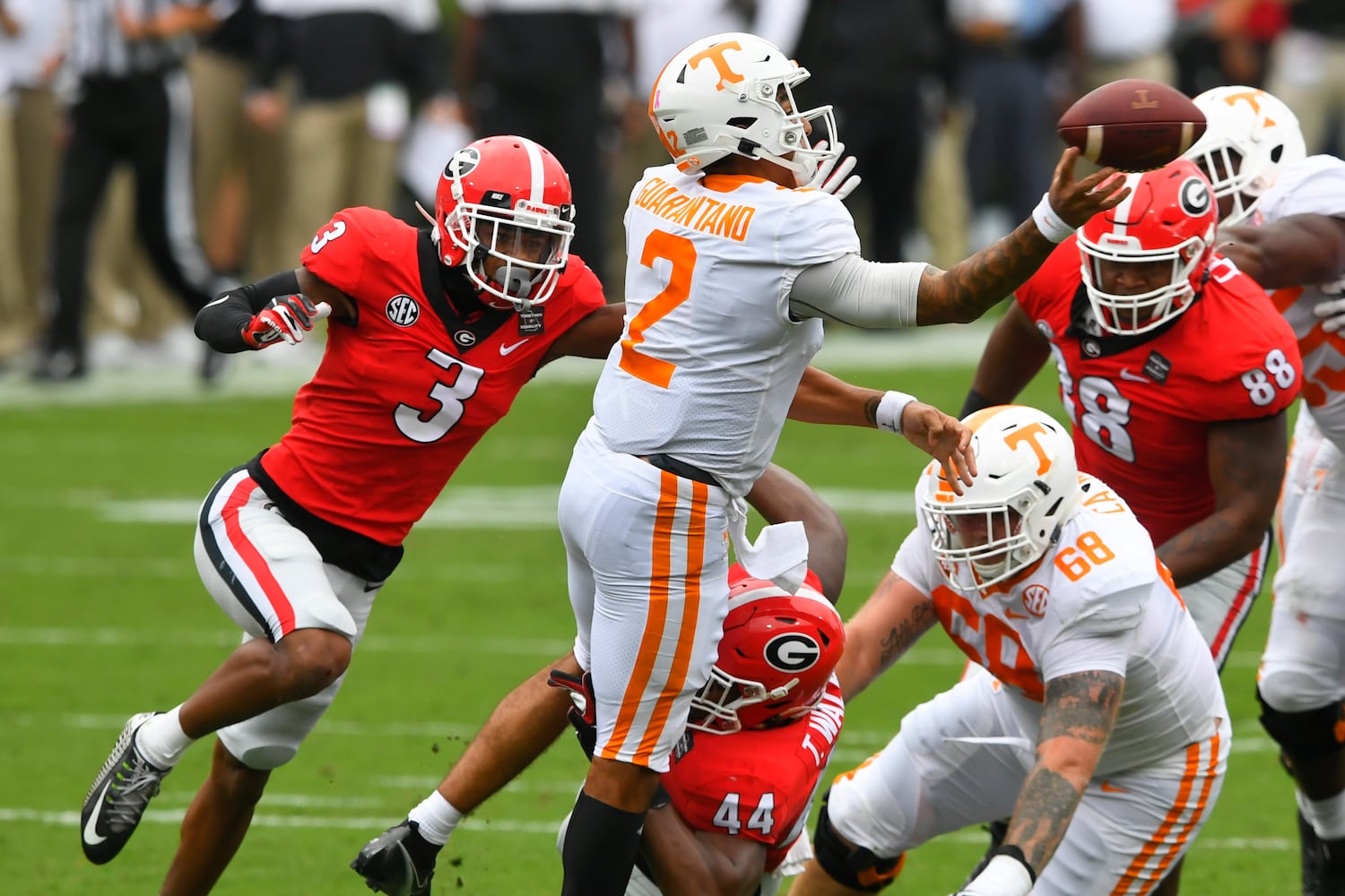 Georgia defensive back Tyson Campbell (3) bears down on Tennessee quarterback Jarrett Guarantano (2) as Georgia defensive lineman Travon Walker (44) tries to bring him down from below during the first half of a football game Saturday, Oct. 10, 2020, at Sanford Stadium in Athens. JOHN AMIS FOR THE ATLANTA JOURNAL- CONSTITUTION