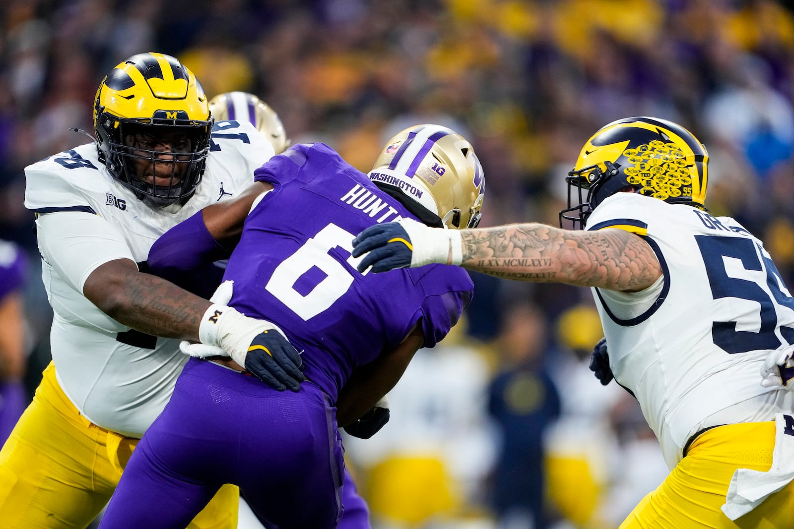 Michigan defensive lineman Kenneth Grant, left, and defensive lineman Mason Graham tackle Washington wide receiver Jeremiah Hunter during the second half of an NCAA college football game Saturday, Oct. 5, 2024, in Seattle. Washington won 27-17. (AP Photo/Lindsey Wasson)