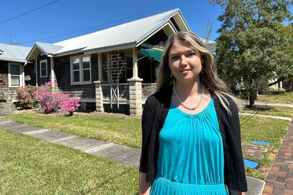 Aliyah Meyer, an official with the St. Johns County Chamber of Commerce, walks through a downtown neighborhood in St. Augustine, Fla., which has become a top remote work hub in the U.S. during the 2020s, on Thursday, March 13, 2025. (AP Photo/Mike Schneider.)