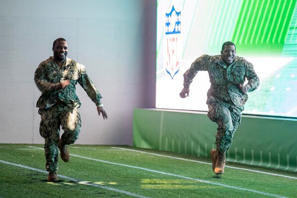 U.S. Navy Petty Officer first class Dchuan Parker (left) competes in a race with U.S. Navy Petty Officer second class Michael Walker during the Super Bowl LIII Fan experience Salute to Military day at the Georgia World Congress Center in Atlanta, Monday, January 28, 2019. 