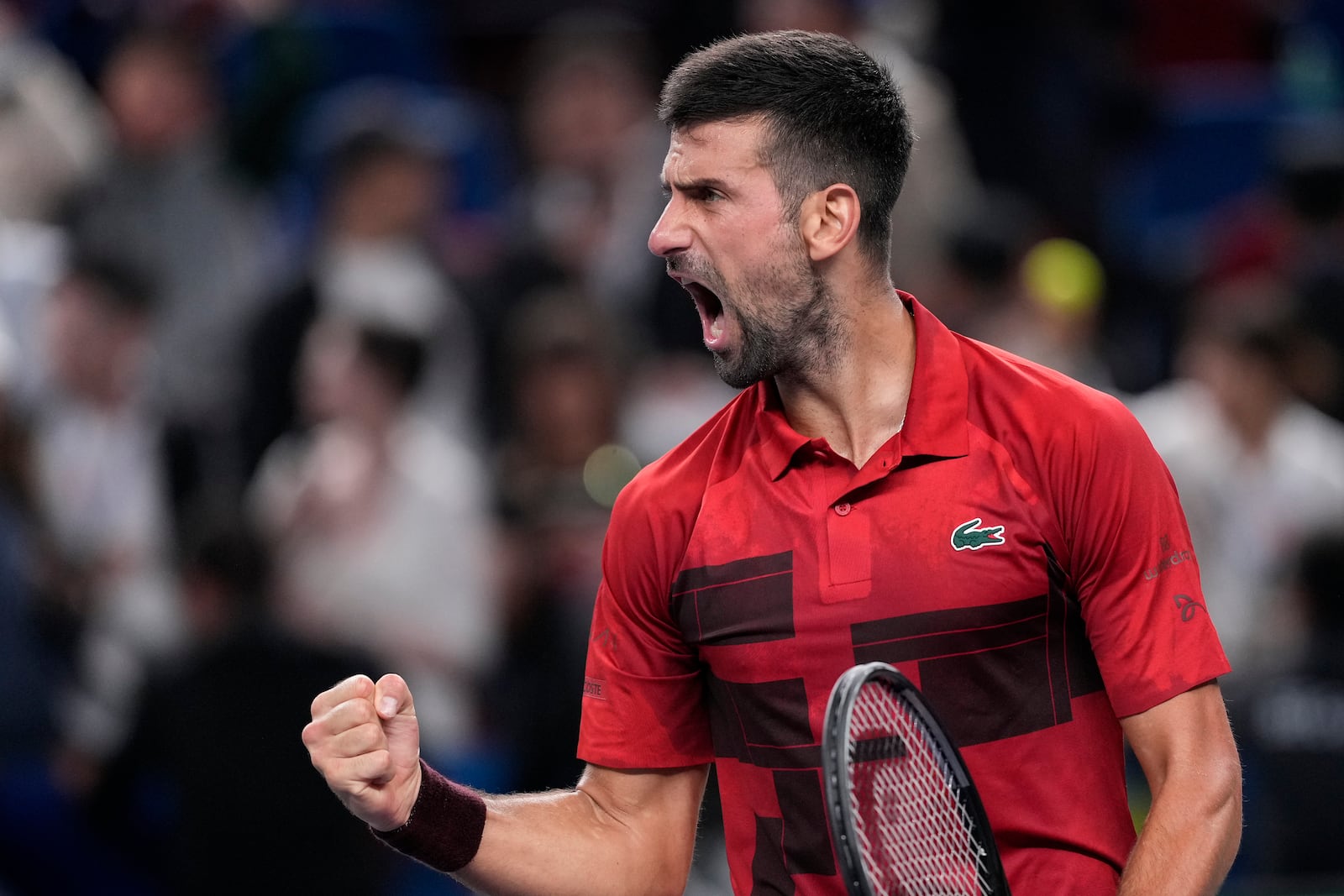 Novak Djokovic of Serbia reacts after defeating Taylor Fritz of the United States in the men's singles semifinals match of the Shanghai Masters tennis tournament at Qizhong Forest Sports City Tennis Center in Shanghai, China, Saturday, Oct. 12, 2024. (AP Photo/Andy Wong)