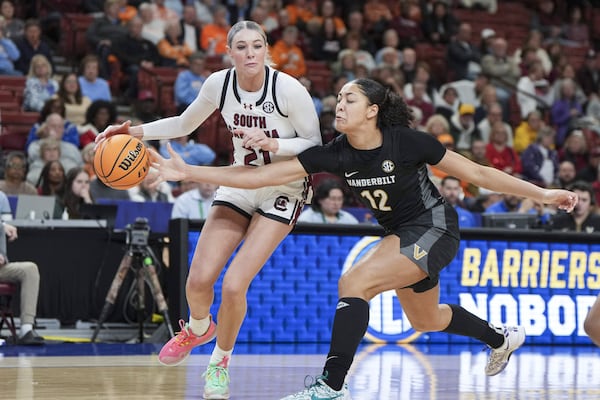 Vanderbilt forward Khamil Pierre (12) knocks the ball away from South Carolina forward Chloe Kitts (21) during an NCAA college basketball game in the quarterfinals of the Southeastern Conference tournament, Friday, March 7, 2025, in Greenville, S.C. (AP Photo/David Yeazell)