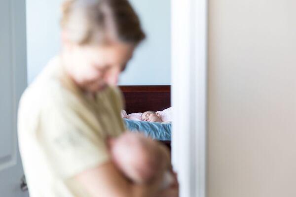 Jenna Buehler is at home holding her daughter, Reilly, while husband Josh rests. Josh had undergone treatment for glioblastoma, the most common and most aggressive form of brain cancer. He recently passed away. This is part of a photo documentary by Jennifer Keenan Giliberto, a professional photographer. CONTRIBUTED BY JENNIFER KEENAN GILIBERTO