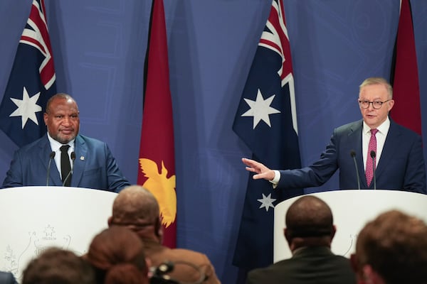 Australian Prime Minister Anthony Albanese, right, gestures during a press conference with Papua New Guinea Prime Minister James Marape in Sydney, Australia, Thursday, Dec. 12, 2024. (AP Photo/Mark Baker)