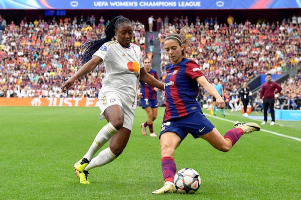 FILE - Barcelona's Aitana Bonmati crosses the ball past Lyon's Kadidiatou Diani, left, during the women's Champions League final soccer match between FC Barcelona and Olympique Lyonnais at the San Mames stadium in Bilbao, Spain, Saturday, May 25, 2024. (AP Photo/Alvaro Barrientos, File)