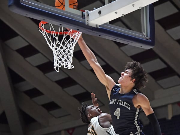 St. Francis' Jusaun Holt (4) goes up for a shot over Greenforest's Lamar Oden (10) Wednesday, March 4, 2020, in Macon.  (Hyosub Shin / Hyosub.Shin@ajc.com)