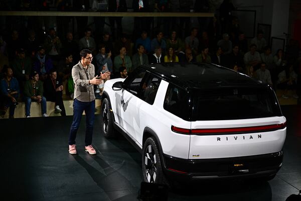 Rivian CEO Robert "RJ" Scaringe speaks at the launch of the Rivian R2 electric vehicle at the Rivian South Coast Theater in Laguna Beach, California, on March 7, 2024. Scaringe said the company is pausing plans to build a new factory in Georgia. (Patrick T. Fallon/ AFP/Getty Images/TNS)