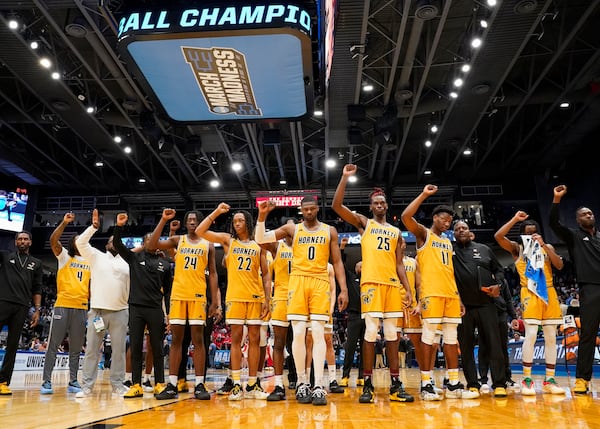 Alabama State players celebrate with fans following their 70-68 win over Saint Francis during a First Four college basketball game in the NCAA Tournament, Tuesday, March 18, 2025, in Dayton, Ohio. (AP Photo/Jeff Dean)