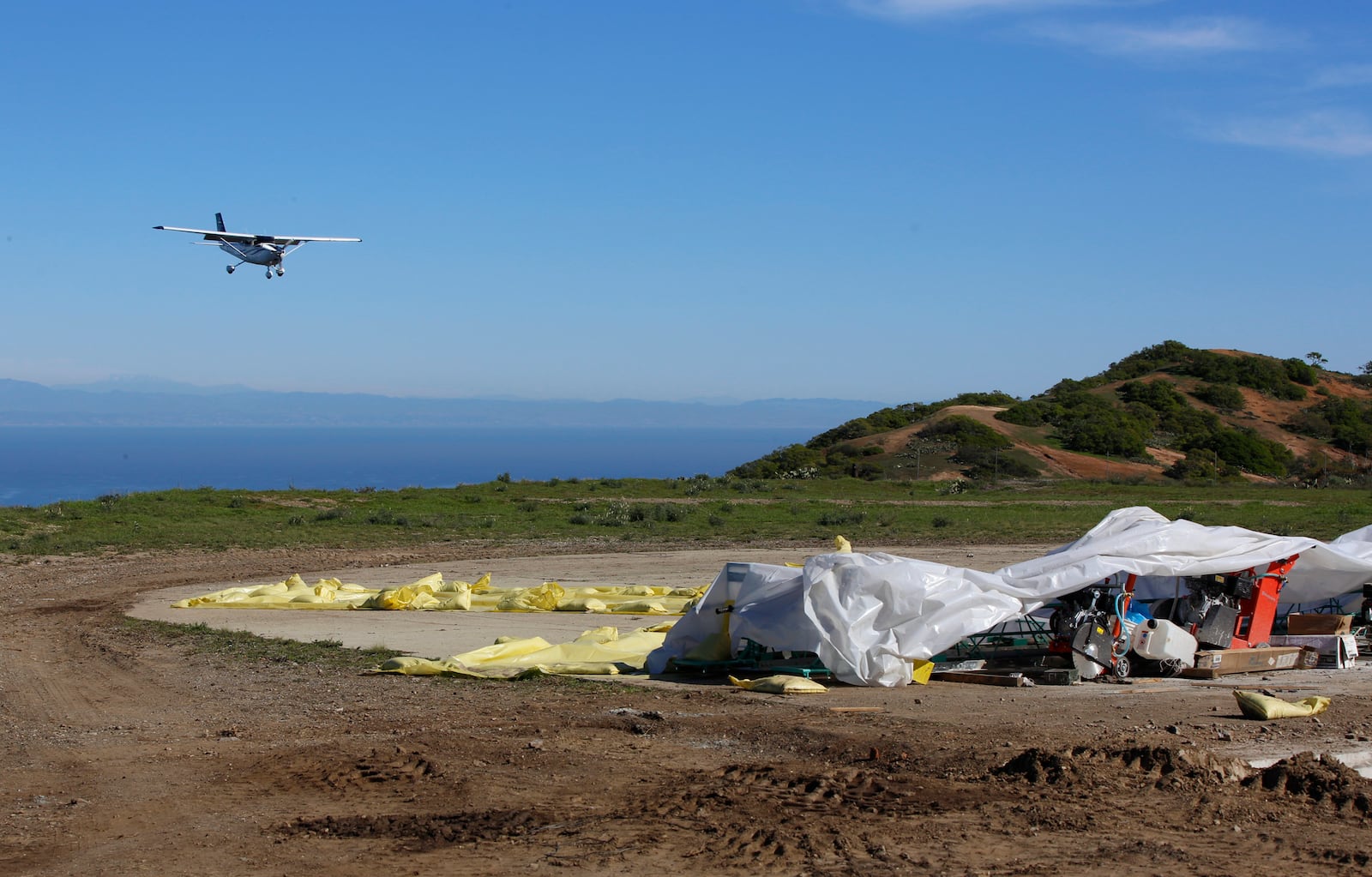 FILE - A small plane lands on Catalina's Airport in the Sky as the U.S. Marines and Navy Seabees rebuild the mountaintop runway on storied Santa Catalina Island, Calif., Friday, Jan. 25, 2019. (AP Photo/Damian Dovarganes, File)