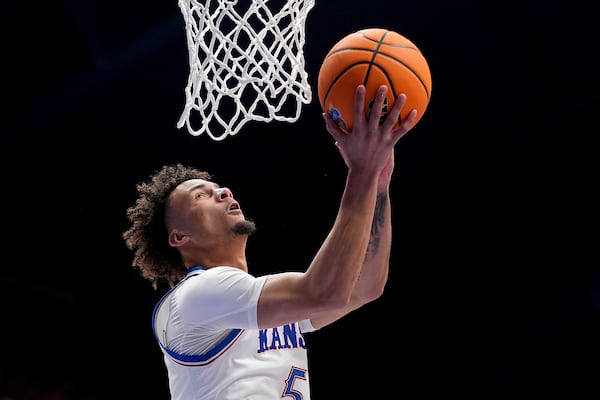 Kansas guard Zeke Mayo shoots during the first half of an NCAA college basketball game against UNC Wilmington Tuesday, Nov. 19, 2024, in Lawrence, Kan. (AP Photo/Charlie Riedel)