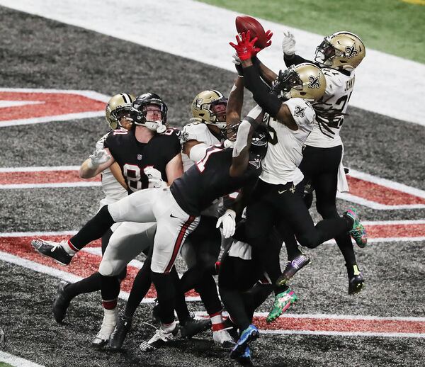 Saints defenders break up a Hail Mary pass to Falcons wide receiver Julio Jones in the end zone as time expires Sunday, Dec. 6, 2020, at Mercedes-Benz Stadium in Atlanta. (Curtis Compton / Curtis.Compton@ajc.com)